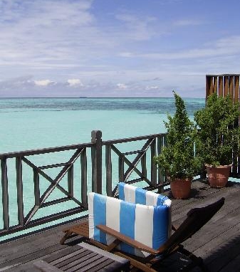 Sun loungers on a private balcony overlooking the turquoise sea